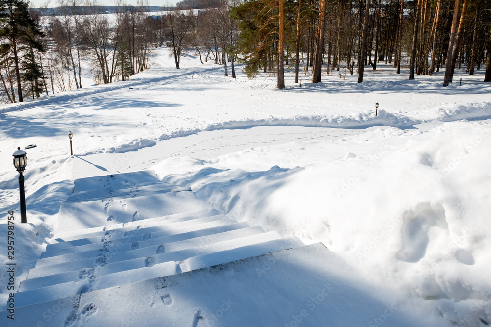 The steps on the lawn go down to the river on a sunny winter day