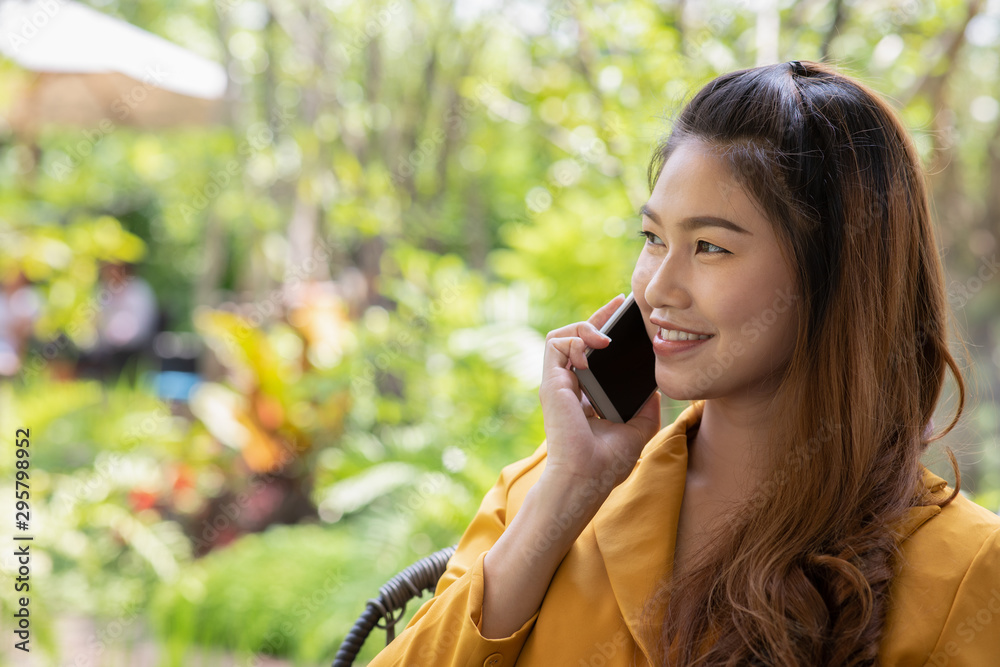 Beautiful Attractive Asian business woman using smartphone in coffee shop cafe smile and happiness with social media and shopping online Beautiful Attractive Asian business woman using smartphone in coffee shop cafe smile and happiness with social media and shopping online