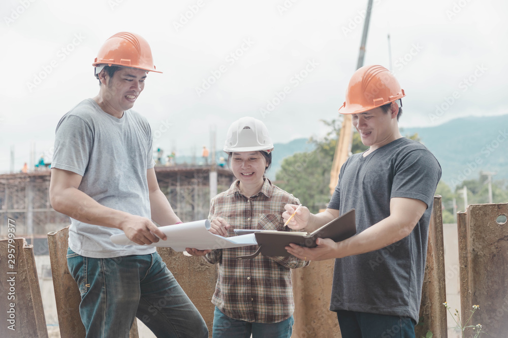 three construction engineers working together in construction site planning for the renovation three construction engineers working together in construction site planning for the renovation