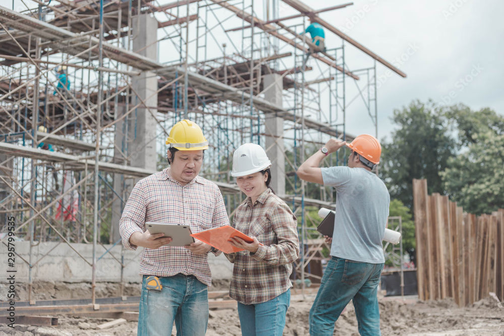 three construction engineers working together in construction site planning for the renovation three construction engineers working together in construction site planning for the renovation