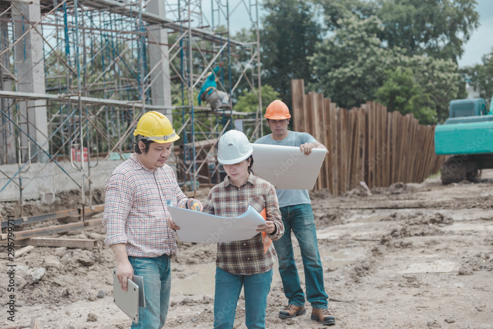 three construction engineers working together in construction site planning for the renovation