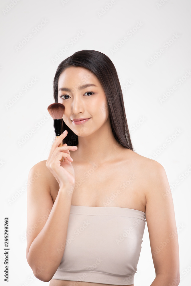 Beautiful Asian young woman smile and holding make up brush with healthy Clean and Fresh skin feeling so happiness and cheerful,Isolated on white background,Beauty Cosmetics Concept Beautiful Asian young woman smile and holding make up brush with healthy Clean and Fresh skin feeling so happiness and cheerful,Isolated on white background,Beauty Cosmetics Concept