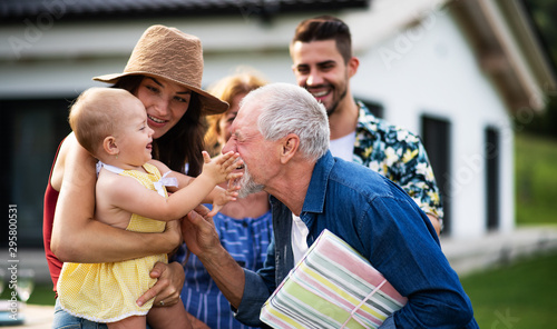 Фотография Portrait of multigeneration family outdoors on garden barbecue.