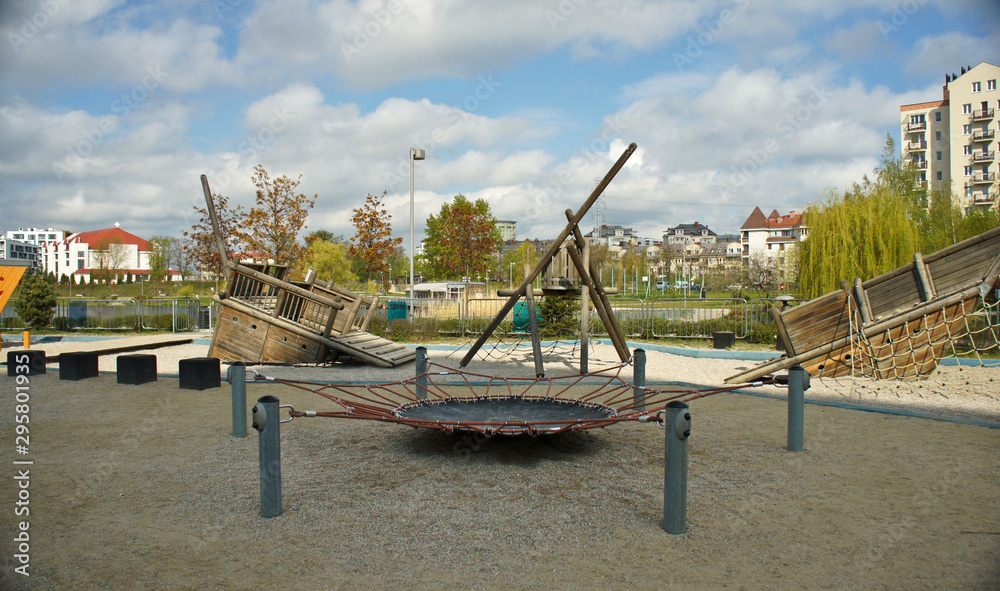 Fototapeta premium Children playground on yard in public park. Urban neighborhood childhood concept.