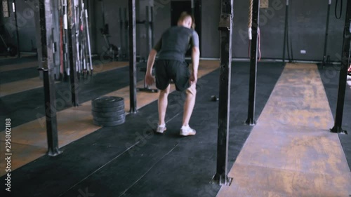 Jumping squats at gym. Effective exercises for great shape. lunch short workout. Back view to powerlifting jumps. Male fitness instructor showing jump exercise at loft plase.