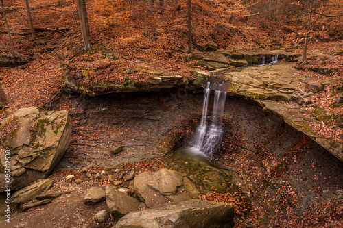 Blue Hens Falls waterfall and fallen leaves of Cuyahoga Valley National Park with foliage view, Ohio USA in autumn