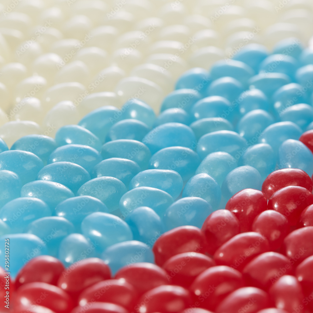 Assorted caramels of different flavors are arranged in the colors of the Russian flag. Vertical image. Assorted caramels of different flavors are arranged in the colors of the Russian flag. Vertical image.