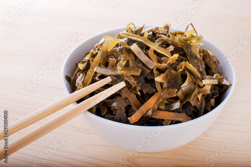 Wakame seaweed salad with sesame seed. Traditional Japanese food. Top view. photo