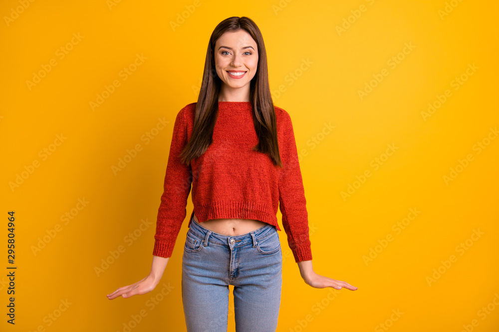 Portrait of positive cheerful girl have fun enjoy her free time with friends look stare feel content candid emotions wear red pullover sweater isolated over yellow color background Portrait of positive cheerful girl have fun enjoy her free time with friends look stare feel content candid emotions wear red pullover sweater isolated over yellow color background