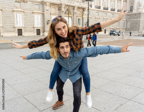 Young crazy tourist couple on holidays having fun while traveling around Europe