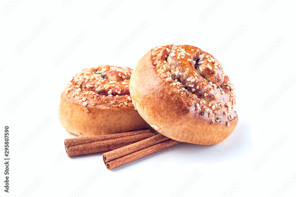 Two cinnamon buns and cinnamon sticks isolated on white background Two cinnamon buns and cinnamon sticks isolated on white background