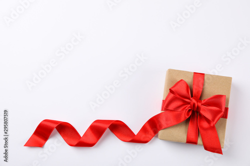Beautiful gift box with red bow on white background, space for text