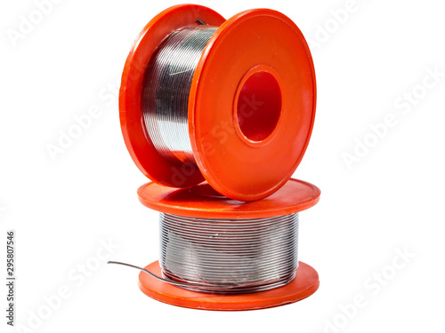two orange coils of fine solder isolated on a white background
