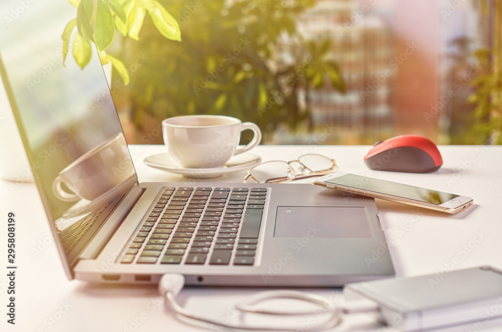 Laptop on a window background on a bright sunny day Laptop on a window background on a bright sunny day