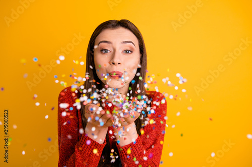 Valokuvatapetti Photo of sweet cute nice cheerful fascinating girl blowing confetti with lips po