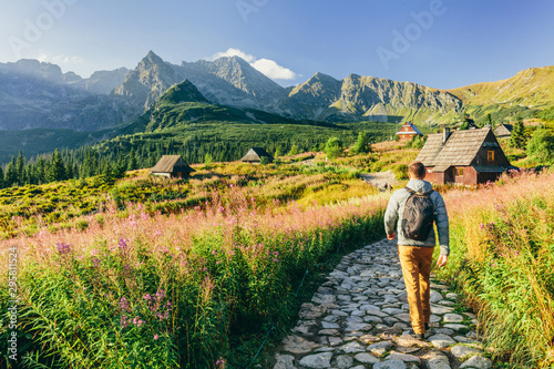 Man walking on hiking trail in Tatra mountains in Poland