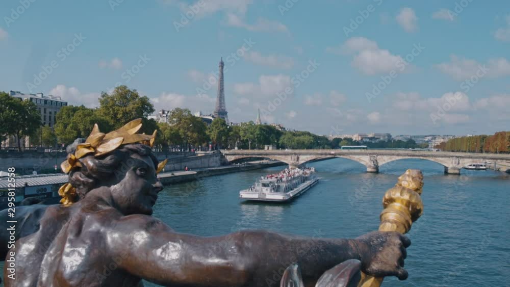 4K Seine river from Pont Alexandre III in Paris, the Eiffel tower in the background and a boat crossing the river during daytime - Slow Motion