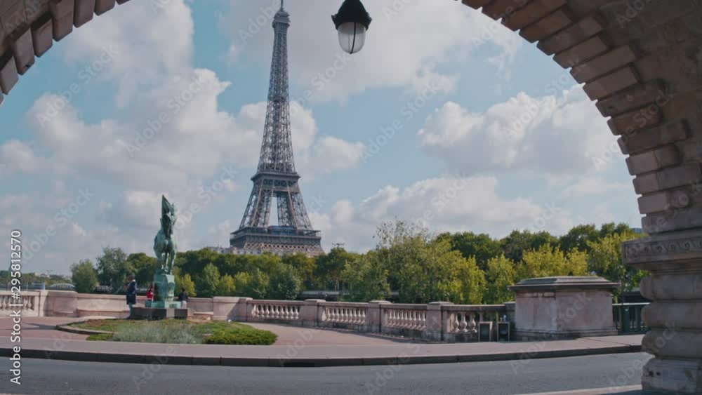 4K Eiffel Tower and statue La France renaissante on Pont de Bir-Hakeim, view from an arch during daytime, Paris, France - Slow Motion