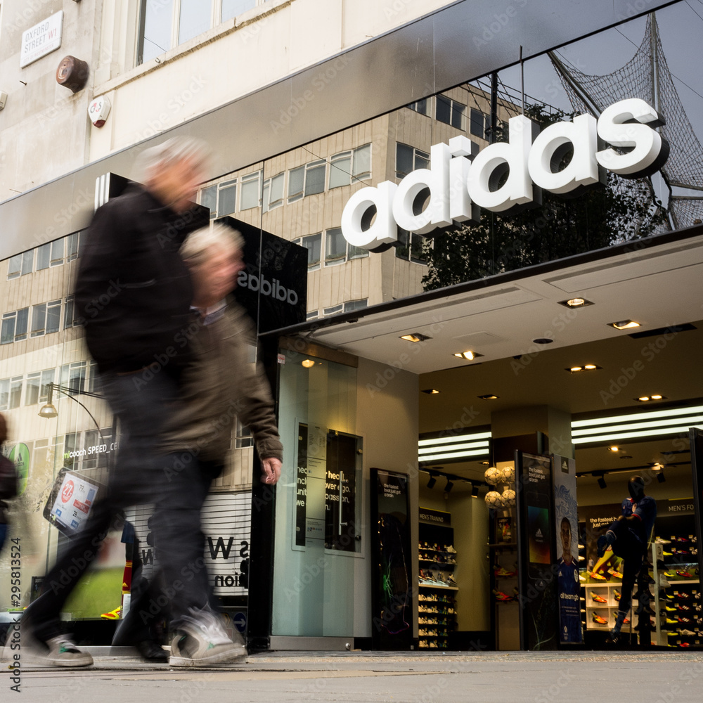 Adidas sports store. Anonymous shoppers walking past the Adidas sports  retailer on London's Oxford Street. Stock-Foto | Adobe Stock