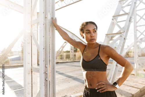 Photo of african american woman looking aside while working out
