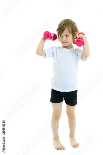 Little girl doing exercises with dumbbells.