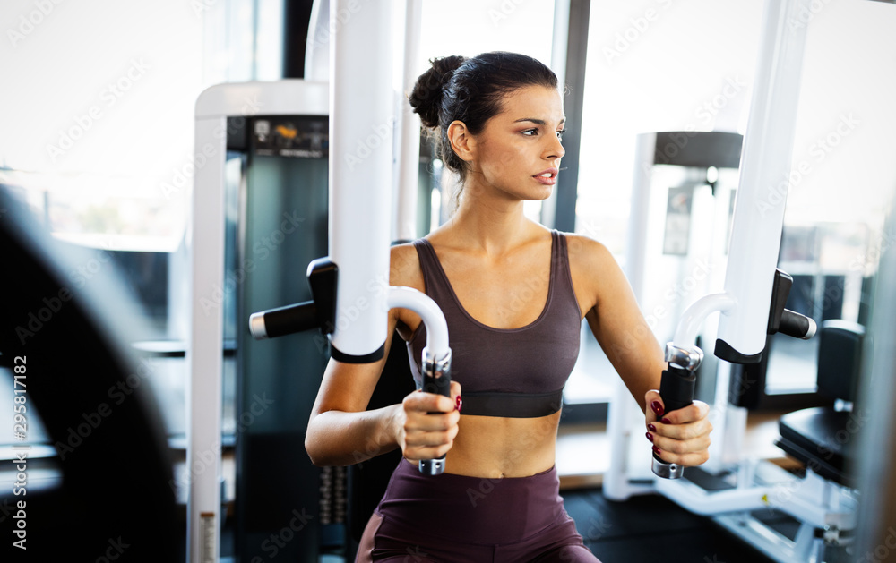 Sport, fitness, lifestyle and people concept. Happy fit people exercising in gym Sport, fitness, lifestyle and people concept. Happy fit people exercising in gym