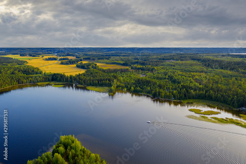 Aerial view of Pulkkilanharju Ridge  Paijanne National Park  southern part of Lake Paijanne. Landscape with drone. Blue lakes  fields and green forests from above on a sunset summer day in Finland.