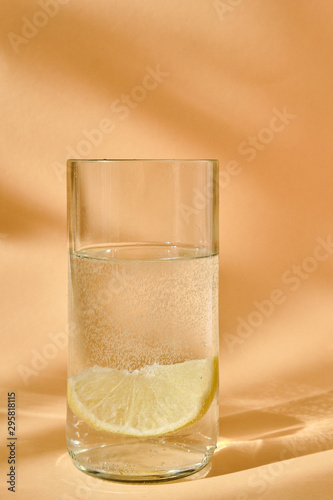Glass of water with lemon. Water bubbles visible
