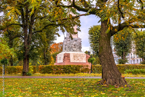 Autumn in central park of Riga with fragment of national monument of freedom