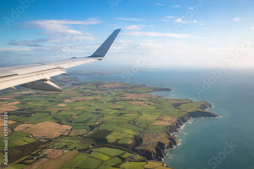 looking out of aircraft window over coastal cliffs on the east coast of Ireland