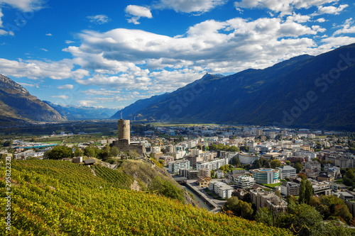 Terraced vineyards above Martigny in Valais Switzerland with medieval castle and Rhône valley. photo