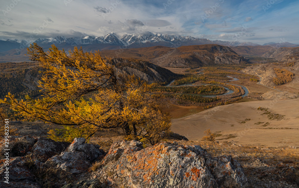 Winding river on a background of mountains and autumn trees