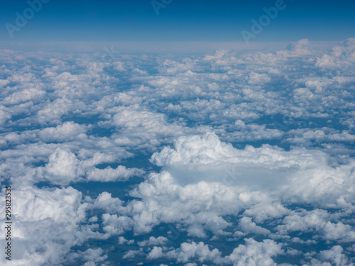 blue sky above clouds from airplane window