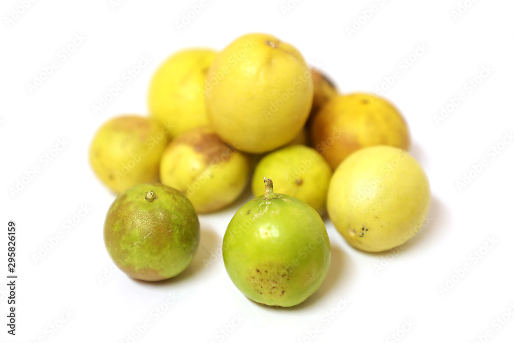 fresh and green lemon with tainted lemon on a white background