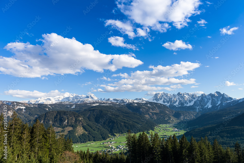 Mount Dachstein, the famous Gosaukamm and the village Gosau in Gosauvalley on a sunny spring day. The last bits of snow are still covering the mountains.