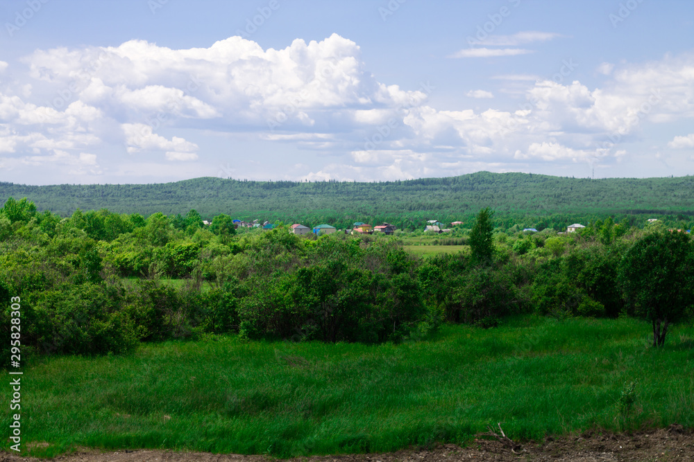 Summer landscape with a green meadow and blue sky. Summer landscape with a green meadow and blue sky.