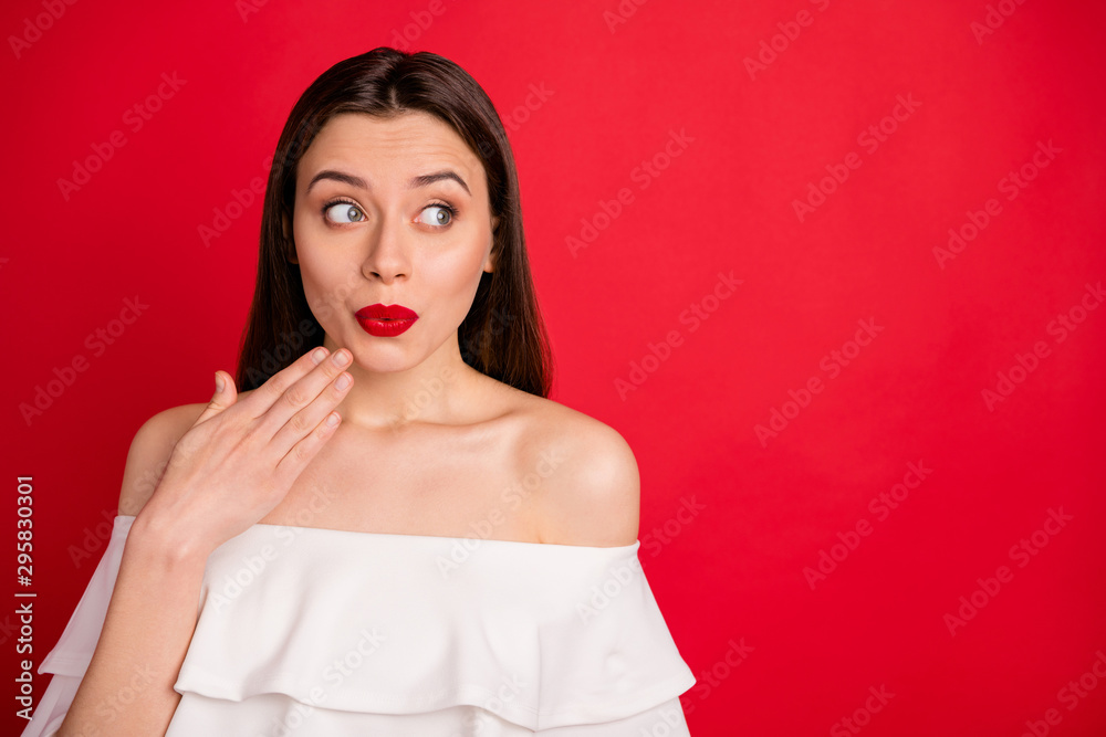 Portrait of impressed person place hand near chin face look wear off-shoulders isolated over red background Portrait of impressed person place hand near chin face look wear off-shoulders isolated over red background