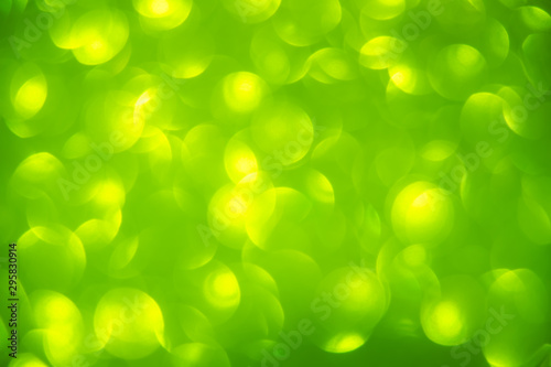 abstract yellow circle light on green background. Green blurred backdrop wallpaper.