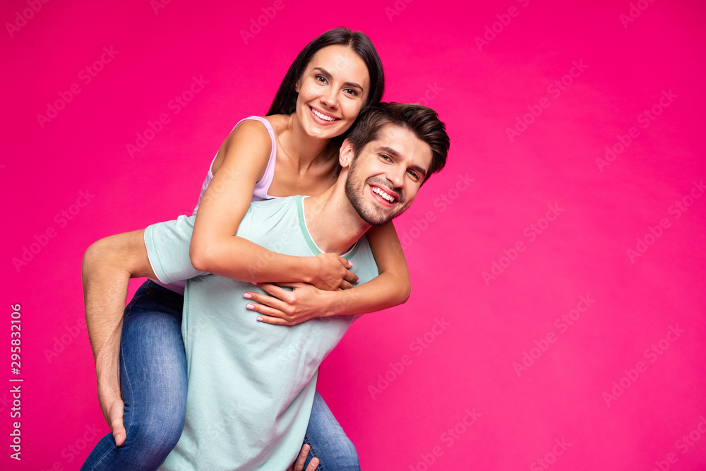Photo of funny guy and lady holding piggyback spending best free time wear casual clothes isolated vibrant vivid pink color background Photo of funny guy and lady holding piggyback spending best free time wear casual clothes isolated vibrant vivid pink color background