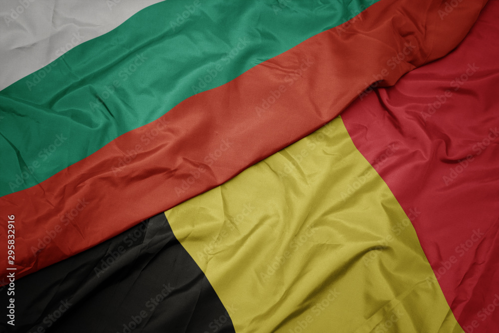 waving colorful flag of belgium and national flag of bulgaria. waving colorful flag of belgium and national flag of bulgaria.