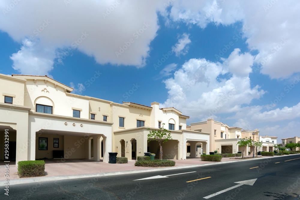 Obraz premium Luxury villa compound housing development with beautiful blue sky with white clouds