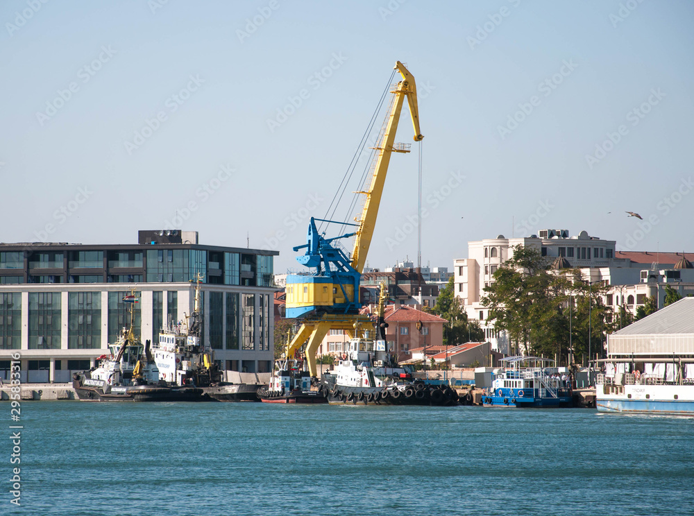 yellow port crane on blue sky background