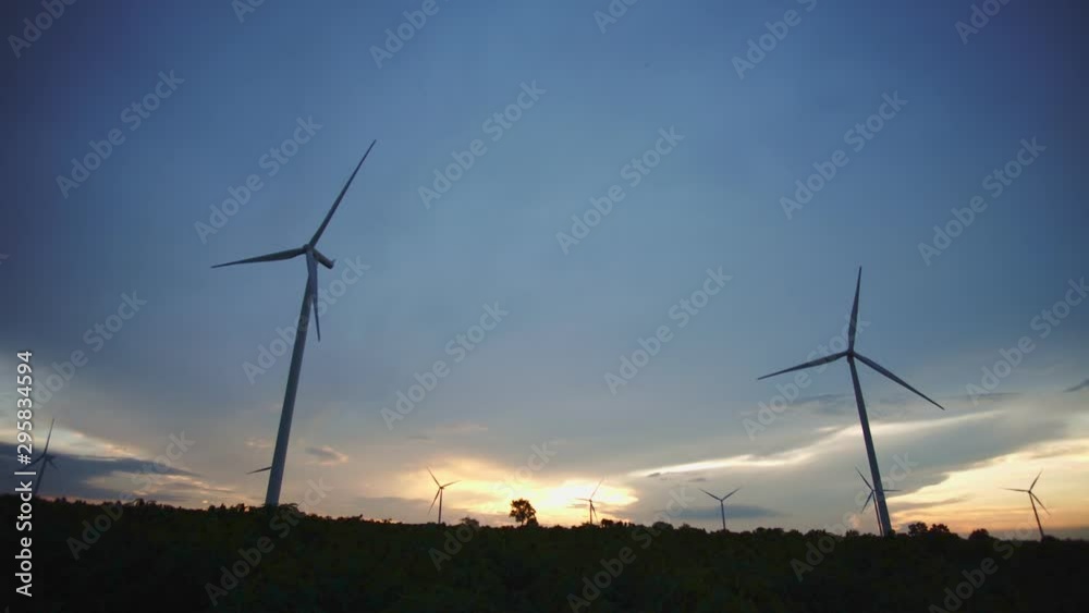 Wind turbines power plant on wind farm at sunset. Wind turbines power plant on wind farm at sunset.