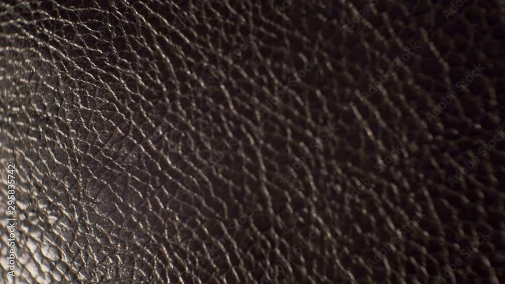 surface smooth polished textured shiny dark leather.close-up. surface smooth polished textured shiny dark leather.close-up.