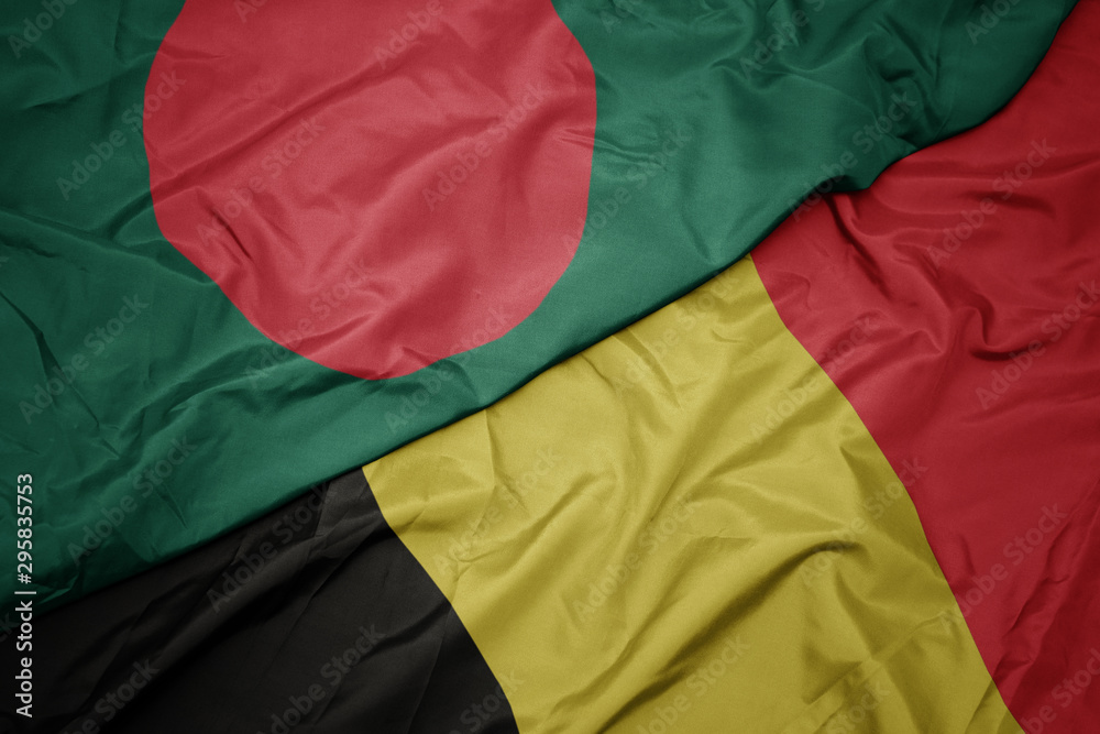 waving colorful flag of belgium and national flag of bangladesh. waving colorful flag of belgium and national flag of bangladesh.