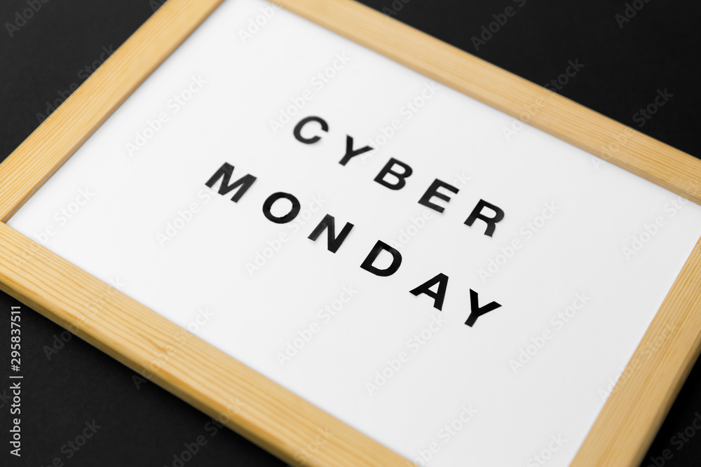 shopping, sale and outlet concept - white magnetic board with cyber monday words on black background shopping, sale and outlet concept - white magnetic board with cyber monday words on black background