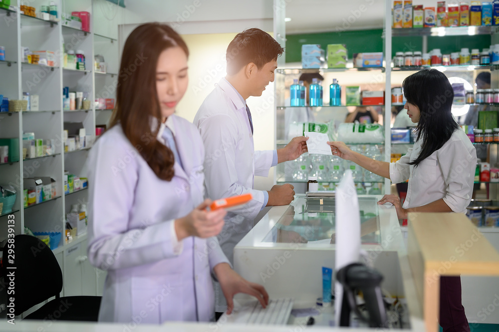 Pharmacist man takes the order of medicine prescription from customer in pharmacy store