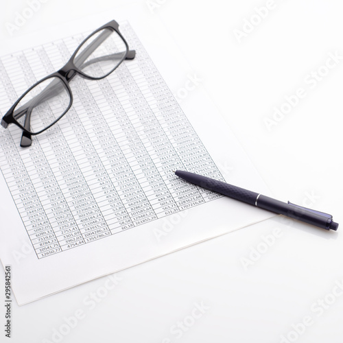 Accounting business concept. Desktop with glasses, spreadsheet and pen.
