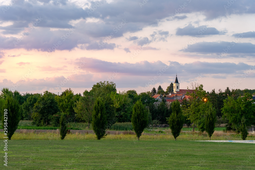 sunset over a village and church in Central Europe Austria