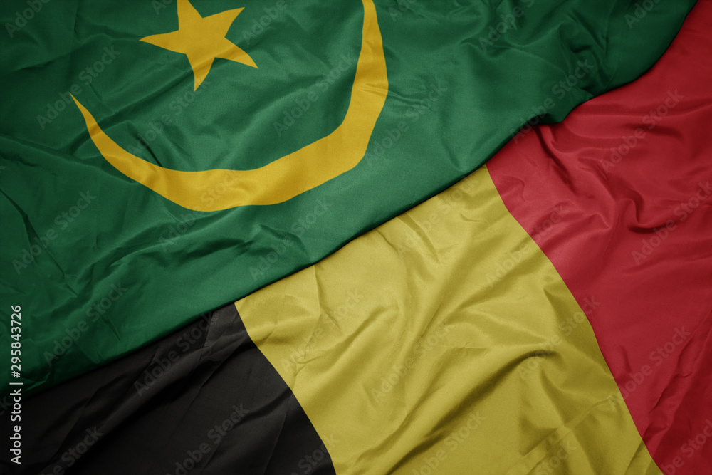 waving colorful flag of belgium and national flag of mauritania. waving colorful flag of belgium and national flag of mauritania.
